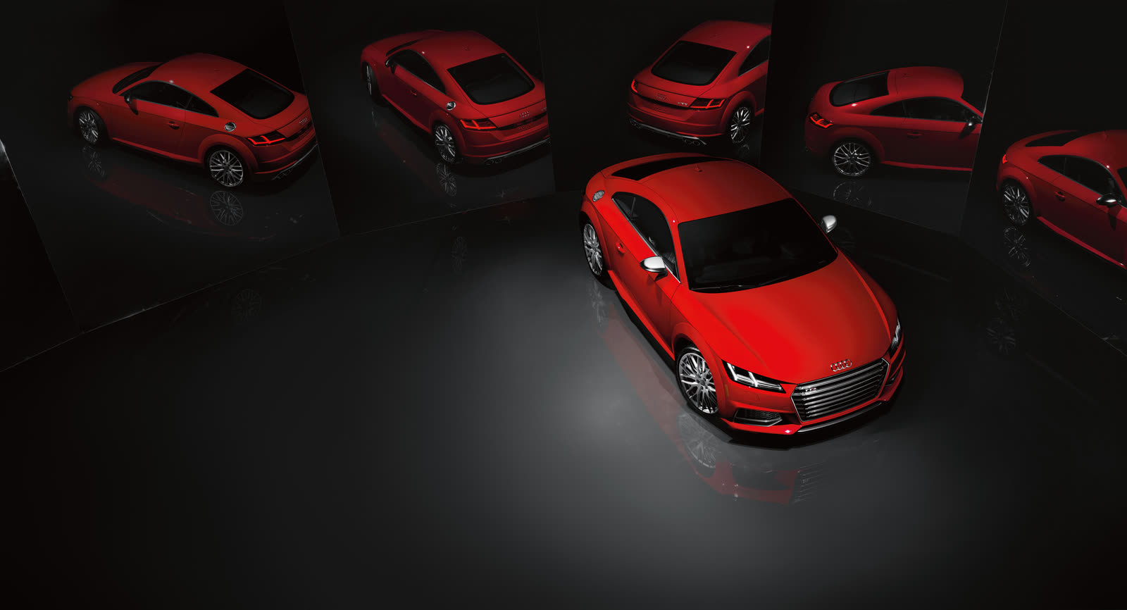 Five red Audi coupes under studio light